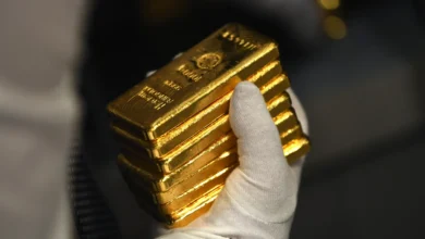 Gold holds firm near record high as markets eye Fed policy signals