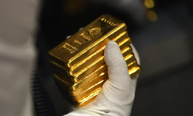 Gold holds firm near record high as markets eye Fed policy signals