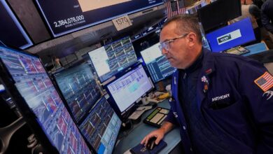 Wall Street edges back from its record heights