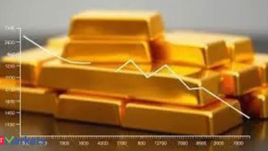 Gold edges lower as dollar climbs to near one-week high ahead of Fed verdict