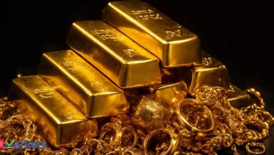 Gold little changed on dollar strength but set for weekly gain