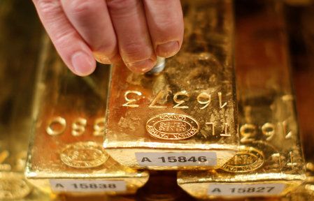 Gold edges lower from near three-week peak on profit-taking