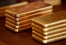 Gold climbs as US dollar softens; STI slips on SATS drag