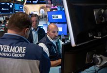 Stocks fall after a surprisingly strong jobs report raises prospects of an interest rate hike