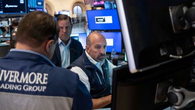 Stocks fall after a surprisingly strong jobs report raises prospects of an interest rate hike